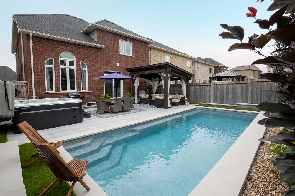 compact fibreglass pool in small Canadian backyard