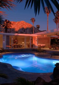 Inground pool at night featuring LED lighting.