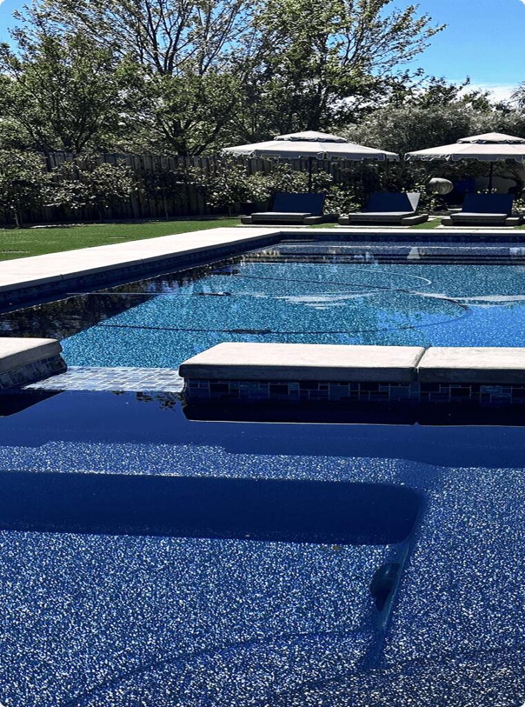 fiberglass inground pool featuring spa and composite pool material