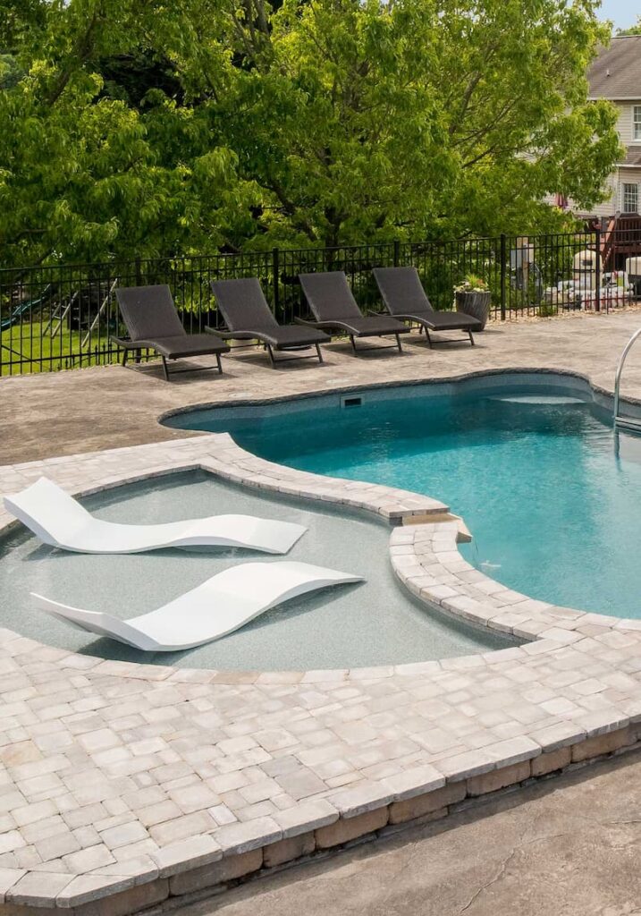 Tanning ledge in a pool under sunny skies.