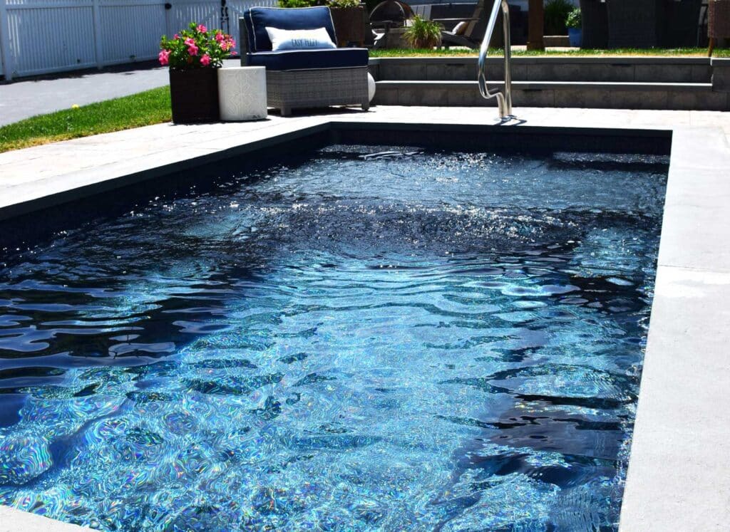 Enchantment fiberglass plunge pool in fenced in backyard