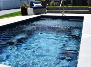 Enchantment fiberglass plunge pool in fenced in backyard